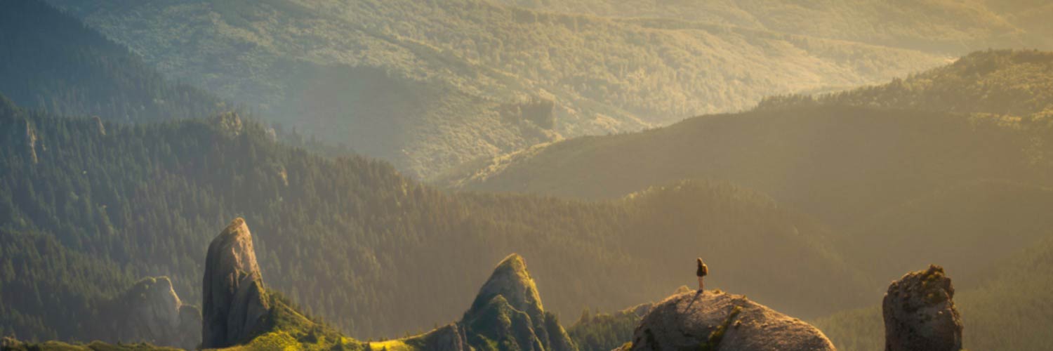 Aerial view of person standing on mountaintop