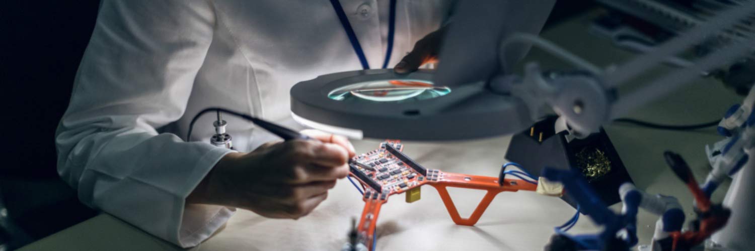 Physicist using magnifier to examine a drone