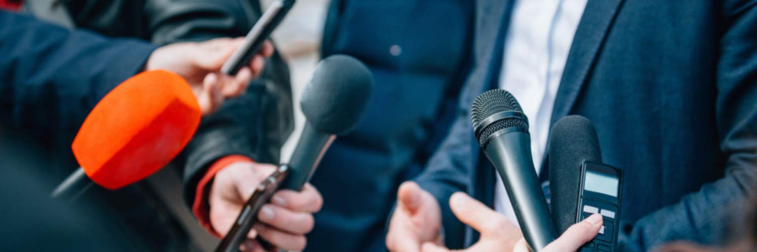 Group of political journalists with microphones