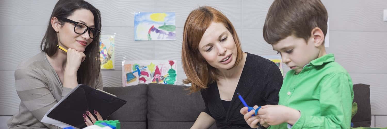 A psychologist assessing a mother and young son