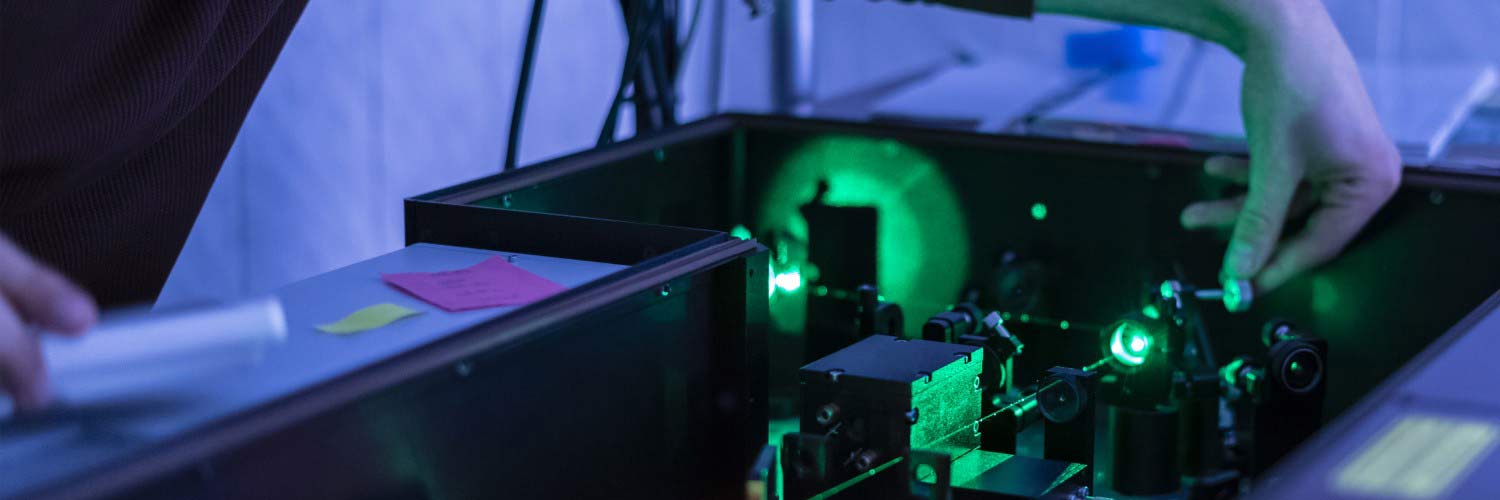 Student using laser in experiment