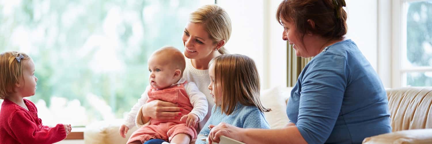 Social worker visiting mother with three young children