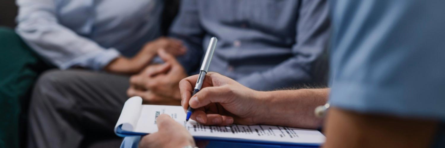 Social worker making notes during an appointment