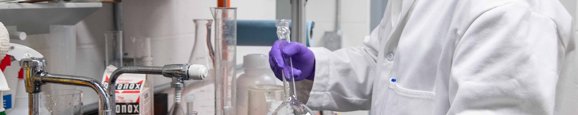 Chemist cleaning glassware
