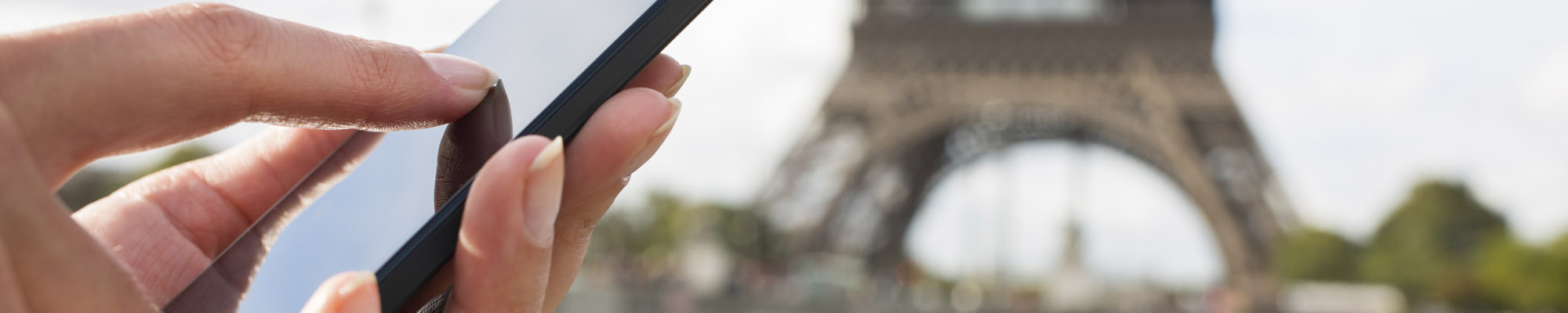 Woman using her mobile phone in front of eiffel tower photo