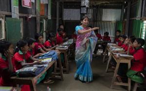 Students listen to their school teacher, Shuma Das during class at the Sahabatpur Daspara Ananda school in Sahabatpur village, Bangladesh on October 12, 2016