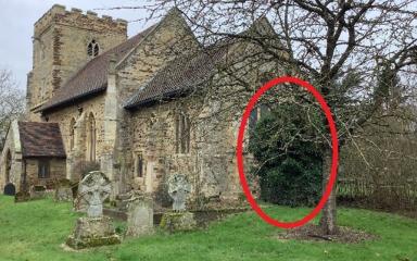Side-view photograph of St Michael's Church at the Walton Hall campus. The area to the right is circled in red to highlight where the tomb discovery was.