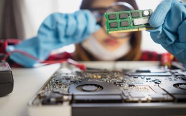 Student examining part of a motherboard