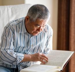 Older gentleman reading a book