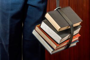 An image of books held by a belt