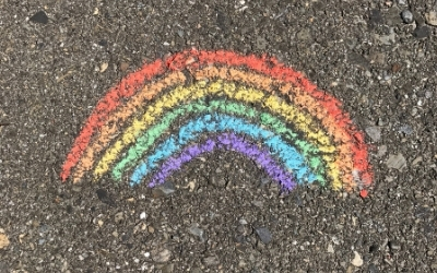 A rainbow drawn by chalk on concrete