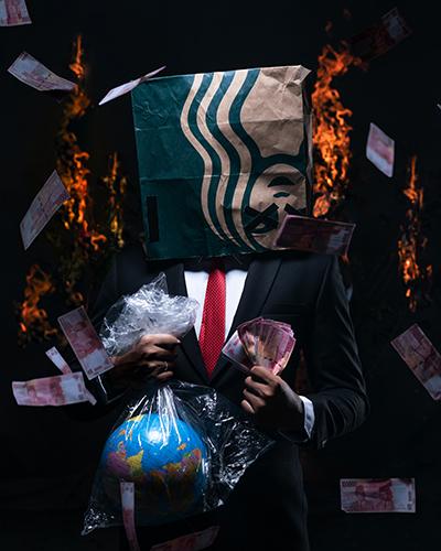 Person in suit suffocating a globe in a plastic bag, a Starbucks bag on their head and cash flying everywhere