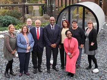 Shaun Wallace from ITV's The Chase stands with members of the OU's Faculty of Business and Law
