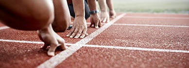 Athletes lined up in the blocks at the beginning of a race
