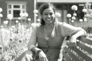 Kesi Mahendran sat in the Open University legacy garden in front of her office