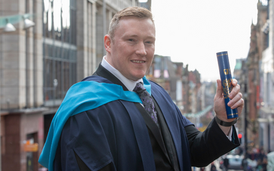 OU graduate Ben Carlin at our Degree Ceremony in Glasgow in October 2022