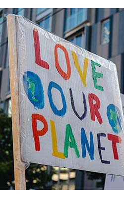 A banner saying 'Love Our Planet', with pictures of two globes