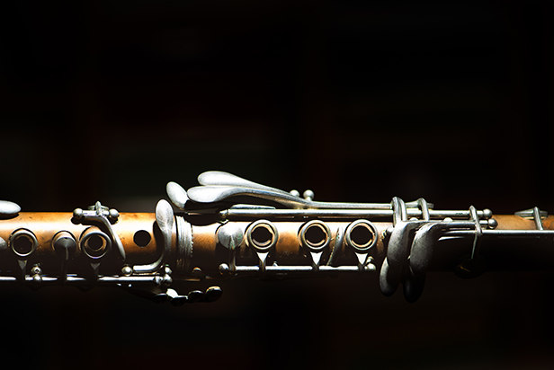 Ancient clarinet detail on a black background