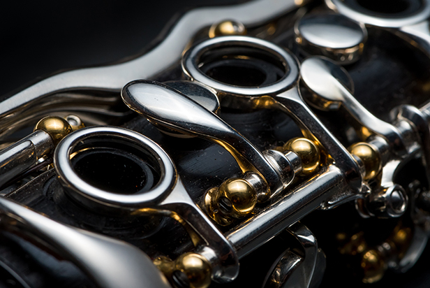 Details of a clarinet with silver keys and golden sockets