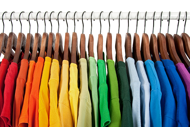 Rainbow colors clothes on wooden hangers
