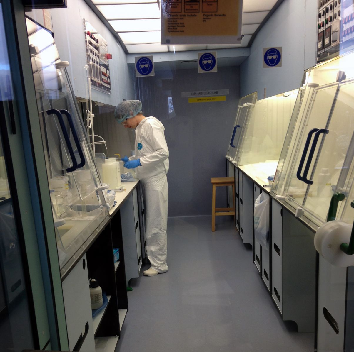 A researcher working in protective clothing in a clean lab