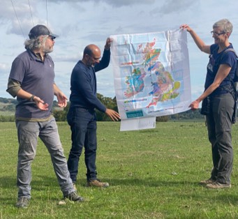 Marcus, discussing the geological map of the UK. Subash and Clare are holding the map. Credit: Geeta Ludhra.