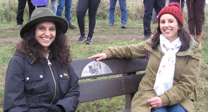 Priya and Geeta sitting on the bench to commemorate the published work of David Bounds.