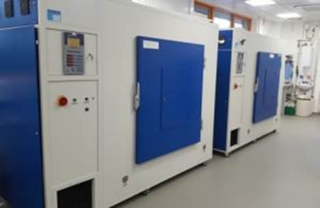 Large scale, two meter high, equipment with large blue doors which are part of the plant growth facilities