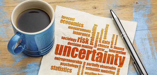 Statistics, coffee mug next to word cloud including the word uncertainty