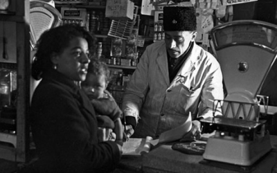 Old photo of mother and son being served in a shop in Butetown