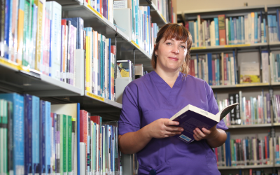 Nursing student Ewa Smaglinska reading a book in a library